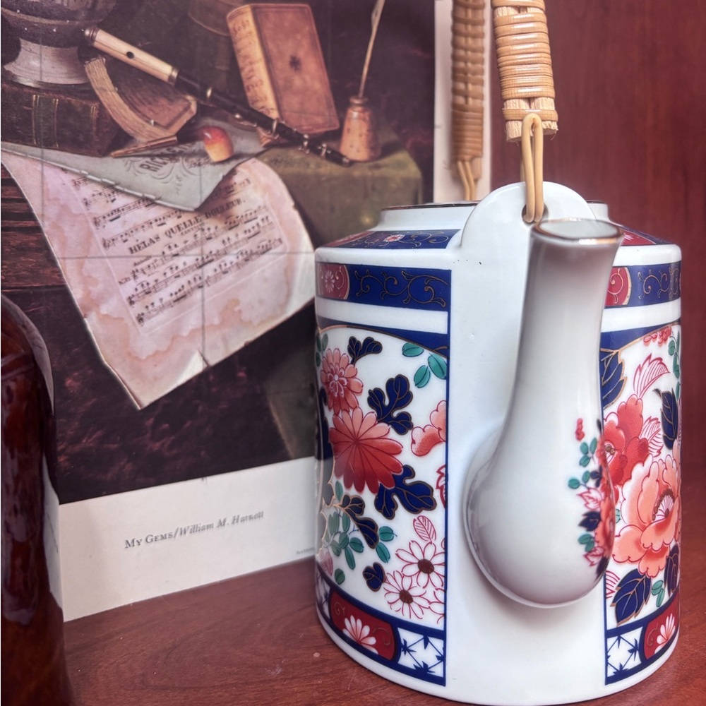 Fred Roberts Company Country Cottage floral wicker handle teapot.